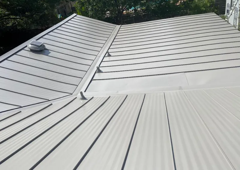 Solar attic fan installed on a metal roof for Roof Ventilation in Homewood